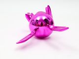 shiny pink christmas ornament with a turtle on it ' s back