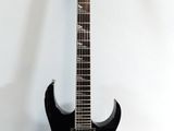 an electric guitar sitting on a stand against a white wall