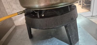 a pot on top of a stove with a hose coming out of it