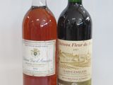 two bottles of wine sitting next to each other on a table