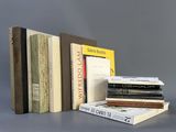 several books are stacked on top of each other on a table