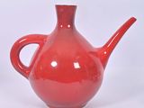 a red teapot with a handle on a white background