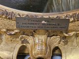 a plaque that says herbert schmallz on the side of a mirror