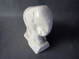 a white elephant statue sitting on a black surface