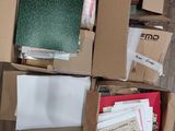 a box full of papers sitting on the floor next to a pile of books