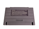a nintendo game console sitting on top of a white surface