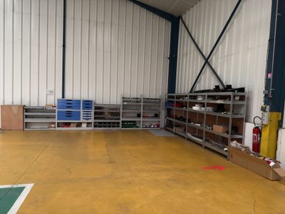 a room with a lot of shelves and a lot of bins
