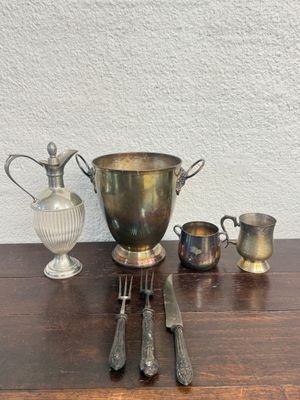an image of a table with silverware and a vase on it