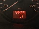 a speedometer with a red display on it