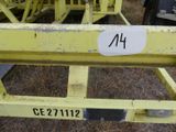 a yellow crane with a number on it in the grass