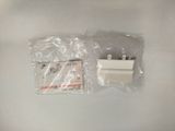 a small white object in a plastic bag on a white surface