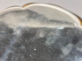 a silver plate with a black and white picture on it