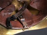 a brown leather hat with a metal buckle on it