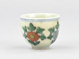 a small cup with a flower design on it