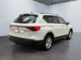 the rear end of a white volkswagen suv parked in a garage