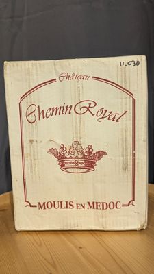 a wooden box with a crown on it on a table
