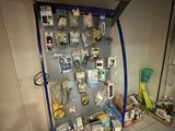 a display case with many items on it in a room