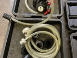 two plastic containers with hoses and a water pump in them