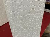 a white refrigerator sitting on a red table in a room