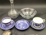 a lot of blue and white dishes and spoons on the table