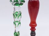 two glass vases that are sitting next to each other