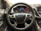 the interior of a car with a steering wheel and dashboard controls