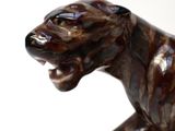a statue of a dog that is sitting on a table