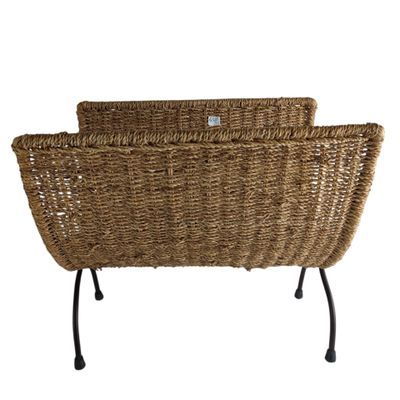 two wicker chairs with metal legs and a basket on top of them