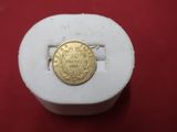 a gold coin sitting on top of a white box