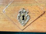 a wooden box with a keyhole in it