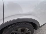 a close up of a car ' s tire on the road