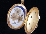 a gold locke with a picture of a flower on it