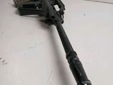 a close up of a machine gun on a white surface