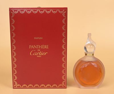 an image of a bottle of perfume sitting next to a box