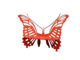 un papillon rouge posé sur une surface blanche