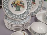 a lot of plates and cups that are on a table