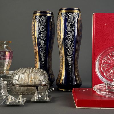 three vases and a book sitting on a table