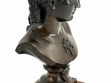 bronze bust of a woman with curly hair on a wooden base