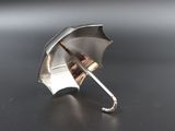 a silver umbrella that is sitting on a table
