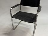 an image of a black leather and chrome chair on a white background