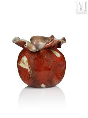 a red vase with a bird on top of it