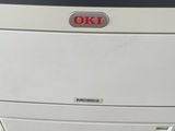 the printer is sitting on top of the cabinet in the room