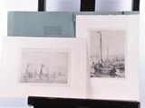 two pictures of boats on display on a easel
