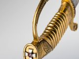 a close up of a gold and silver sword with a star on it