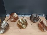 four different types of wire wrapped in different colors on a wooden table