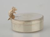 a small silver box with a mouse on it