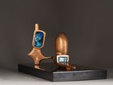sculpture of a wooden object with a blue stone in the middle