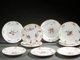 several plates with floral designs are arranged on a table