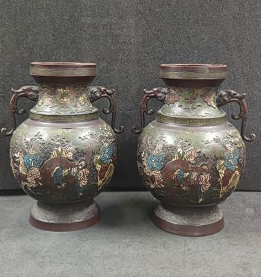 two vases sitting next to each other on a table