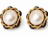 a pair of pearl and gold earrings on a white background